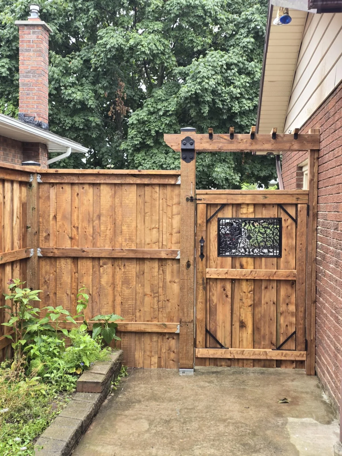 Completed custom wood gate with decorative metal insert
