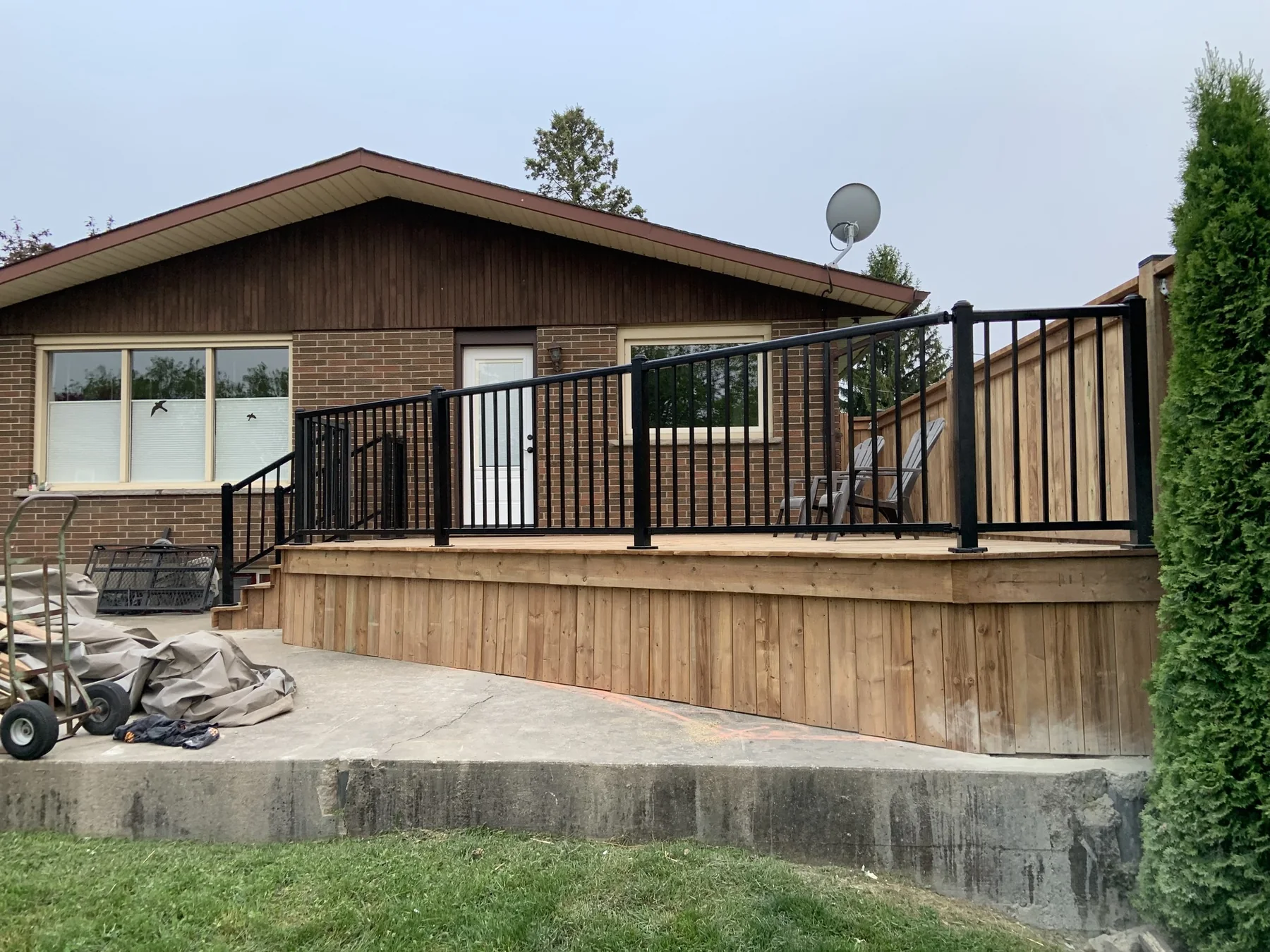 Completed wood deck with black aluminum railing