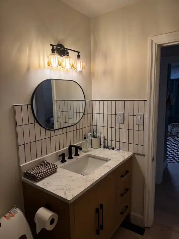 Completed bathroom vanity, tile and lighting