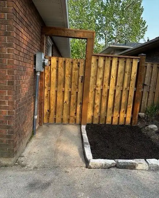Finished wood gate beside a home