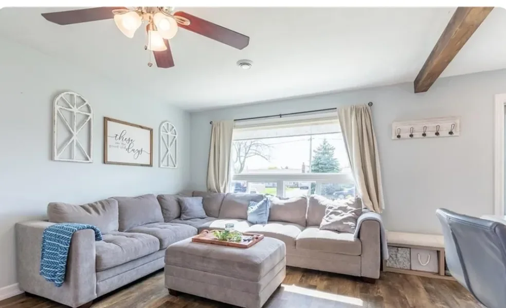 Completed living room renovation with wood-look flooring